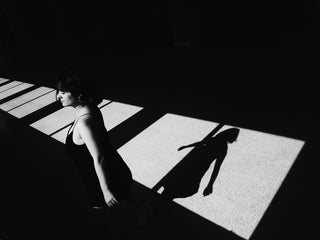 Women walking relaxed in high-contrast sun and shadow