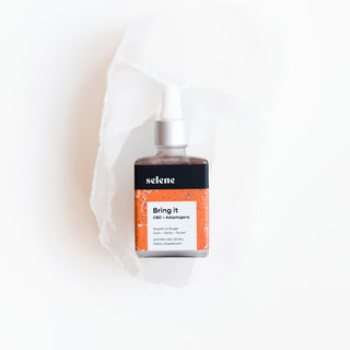 Bottle of grapefruit ginger flavored broad spectrum cbd and adaptogen oil